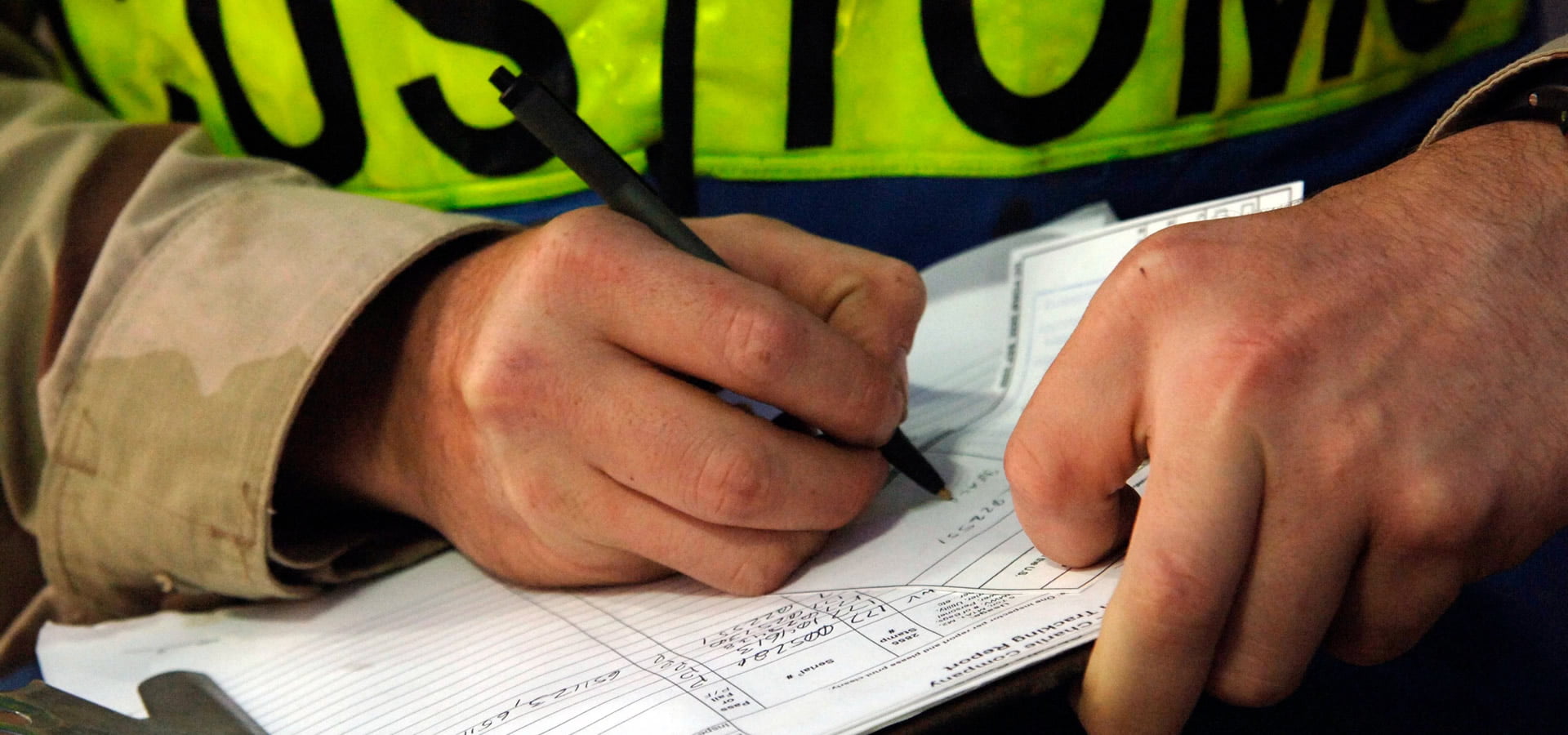 Customs officer completing an import declaration form